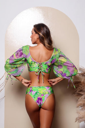 The back of a woman wearing a Açaí Ruffled One Piece by Karla Vivian